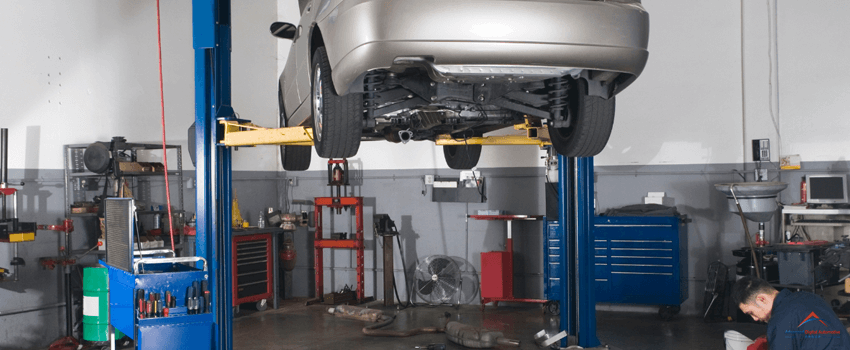 A car inside an auto repair shop.