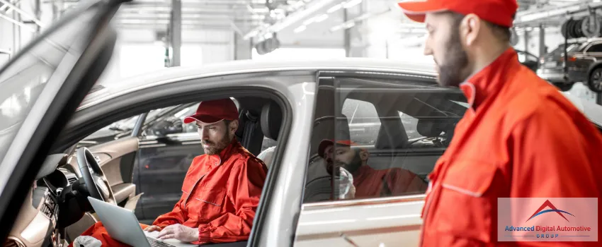 ADAG - Auto mechanic using a laptop in a car 