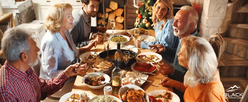 BML - A family of six people enjoying a sumptuous Thanksgiving dinner