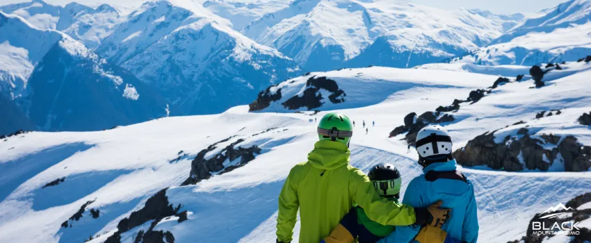 BML - A family of three standing on top of a snowy landscape