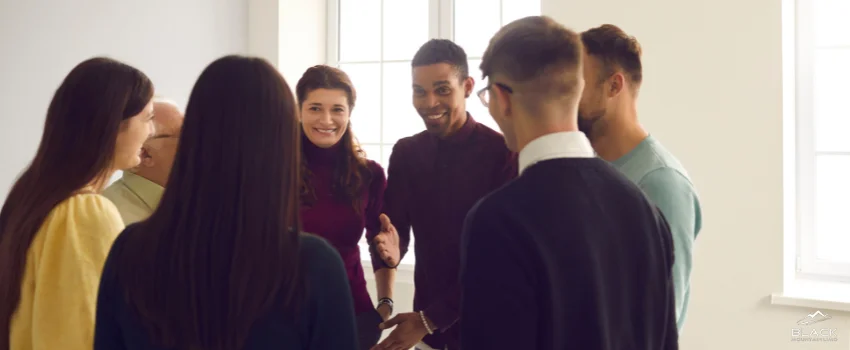 A group of men and women engaged in a discussion.