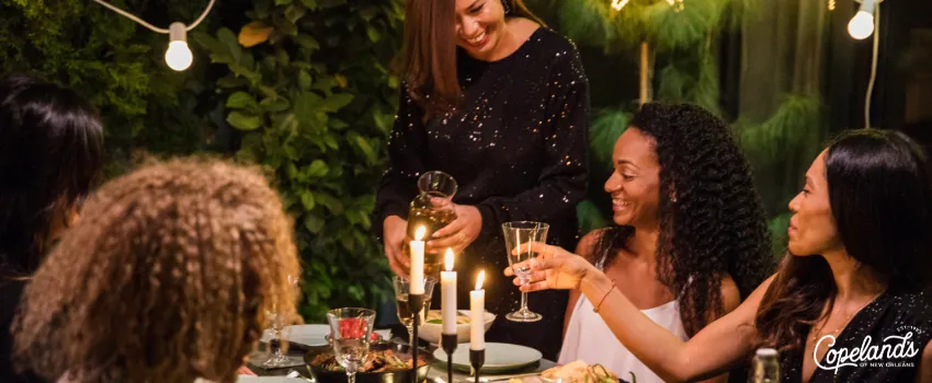 COD - A group of women eating around a dinning table at dinner