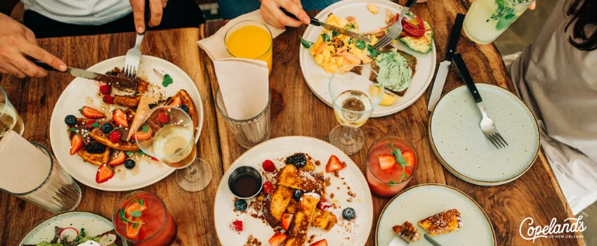 Aerial shot of a group of friends eating brunch in a restaurant | COJ