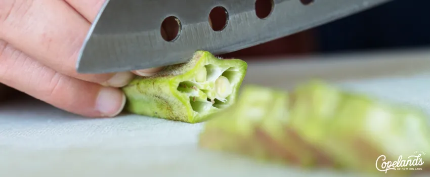 JDC - Chopping an okra on a cutting board 