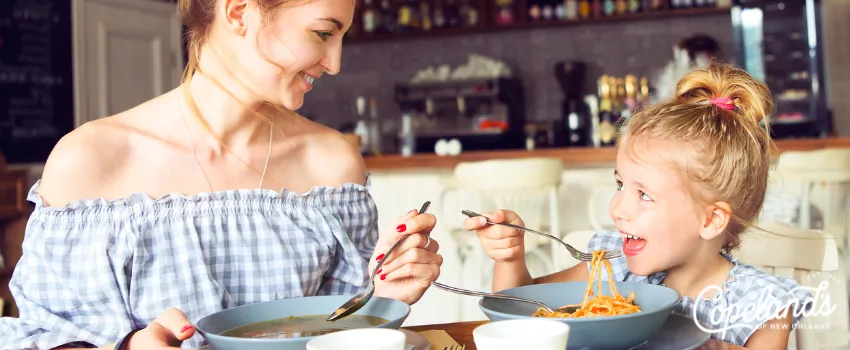 JDC - a mother and a daughter eating in a restaurant 