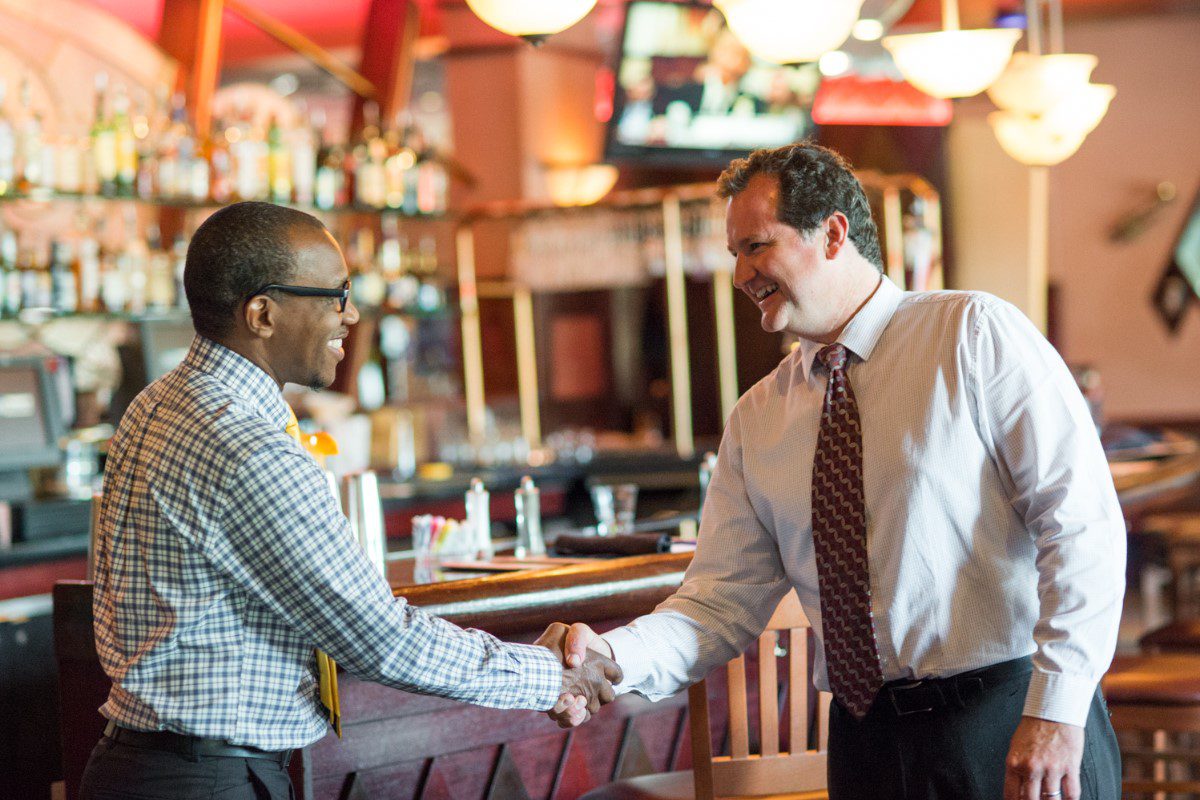 Gentlemen Shaking Hands in A Dining Concept